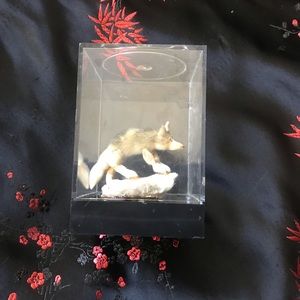 Vintage dollhouse miniature coyote on rock